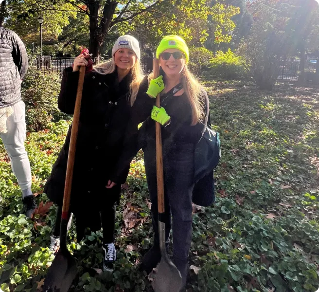 thrive employees shoveling in a forest